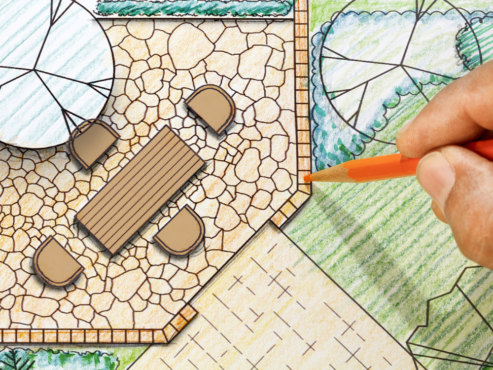 Garden Design plans, hand colouring in with orange pencil