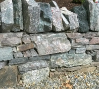 Natural stone wall with big and small stones