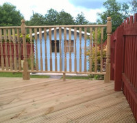 Close up of finished garden deck with blue shed in the background
