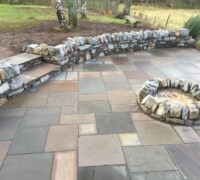 Paved patio area with stone walls