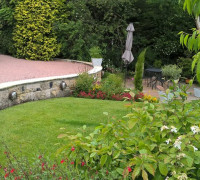 Stone driveway with step down to garden with patio area and Range Rover