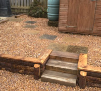 2 height pebbled area with wooden beams