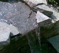 small waterfall into pond