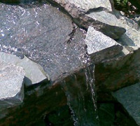 small waterfall into pond