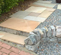 Stone paving slab steps with natural stone wall
